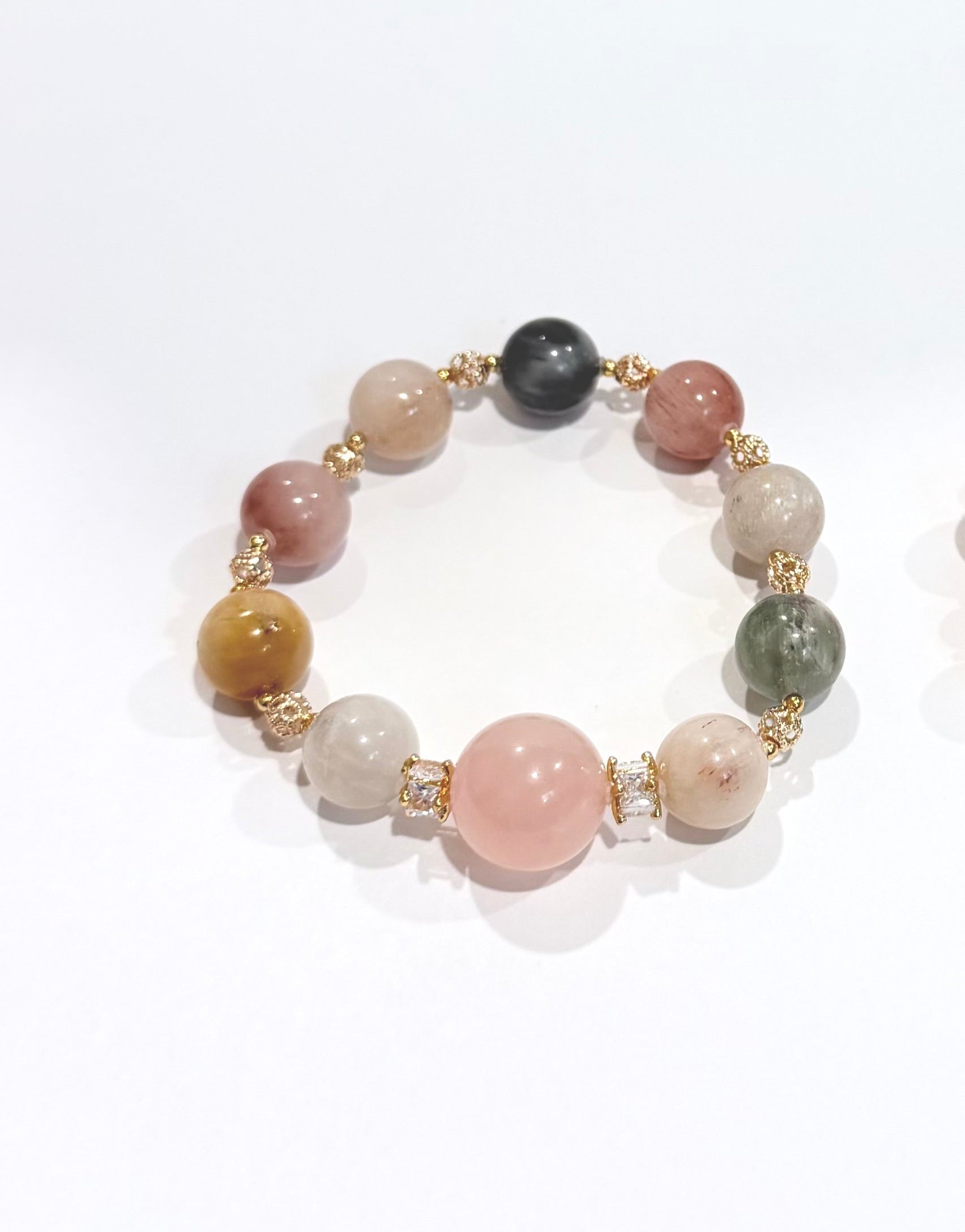 Two beaded bracelets with multicolored beads on a white background