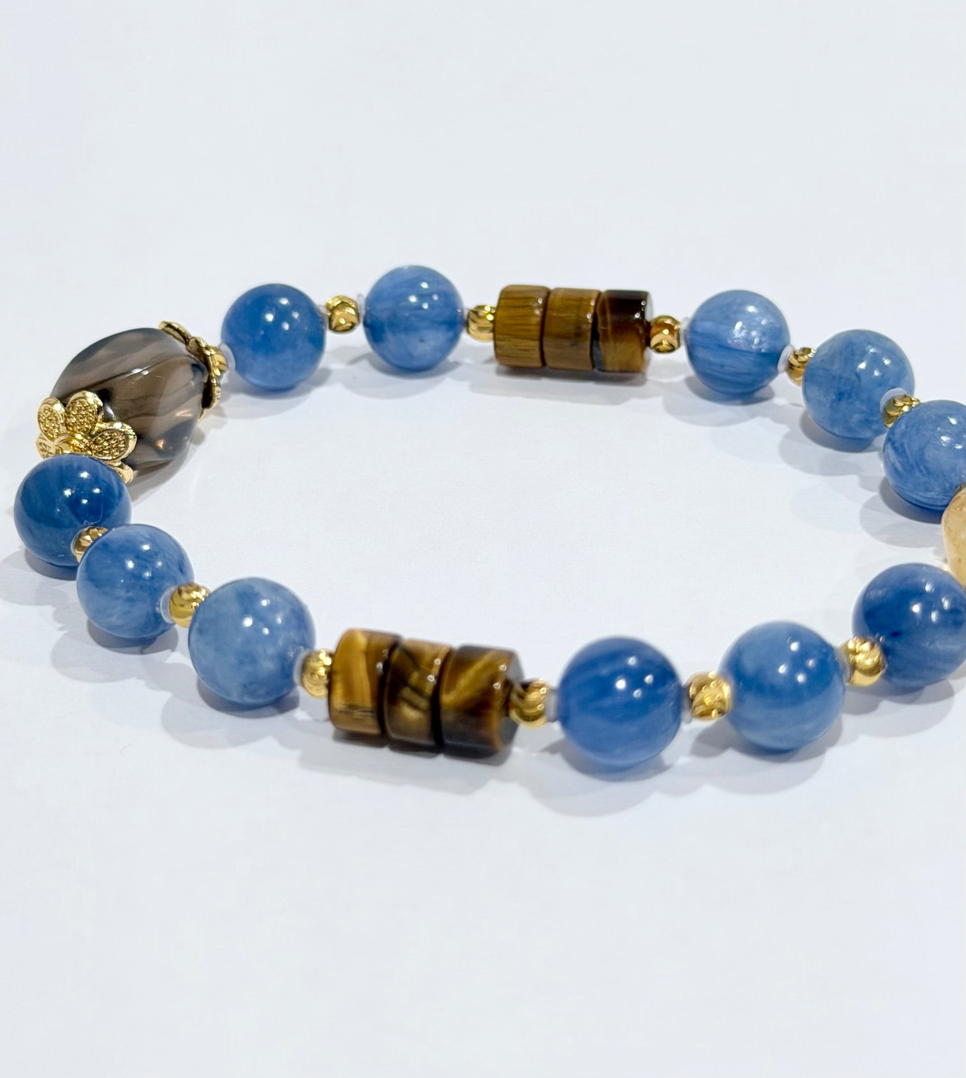 Necklace with blue beads and gold accents on a white background