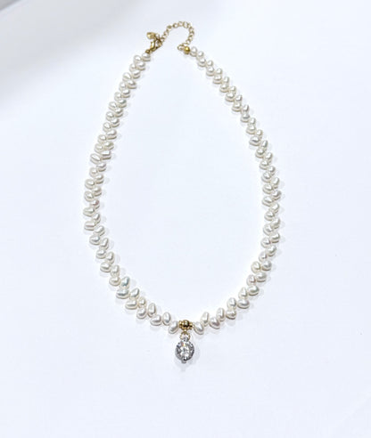 Pearl necklace with a silver clasp on a white background