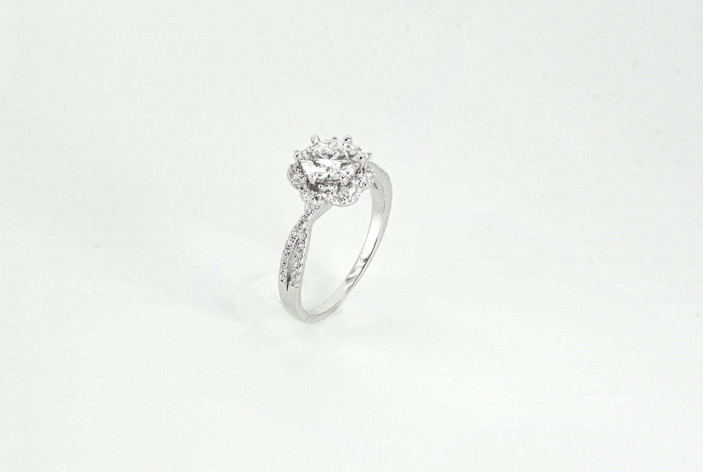 Silver ring with a diamond on a white background