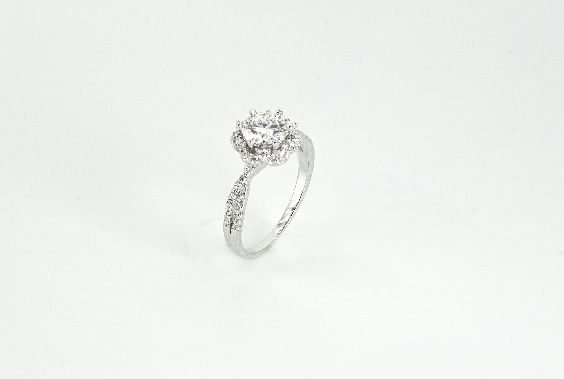 Silver ring with a diamond on a white background