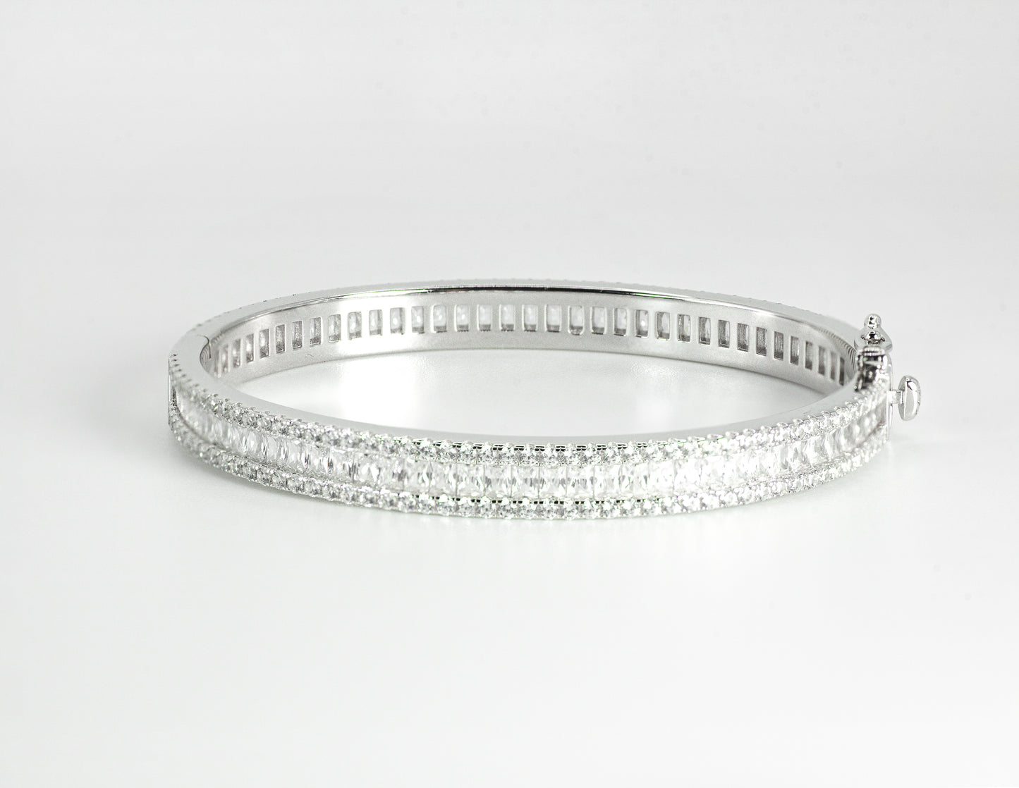 Silver bangle with High-grade Baguette-cut Cubic Zirconias on a light gray background