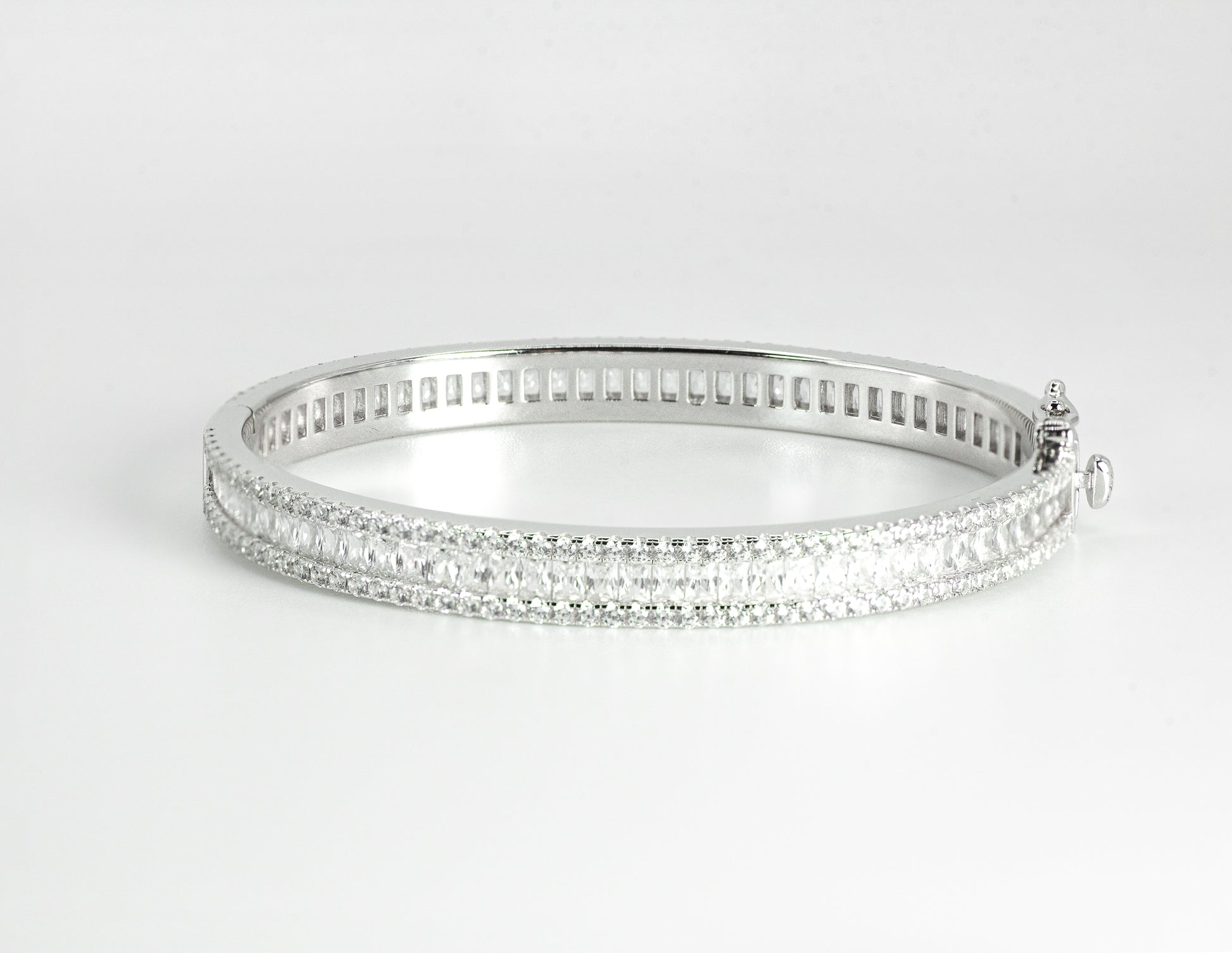 Silver bangle with High-grade Baguette-cut Cubic Zirconias on a light gray background