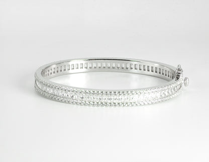 Silver bangle with High-grade Baguette-cut Cubic Zirconias on a light gray background