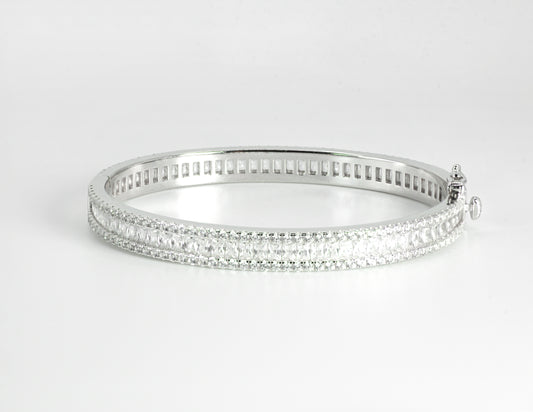 Silver bangle with High-grade Baguette-cut Cubic Zirconias on a light gray background