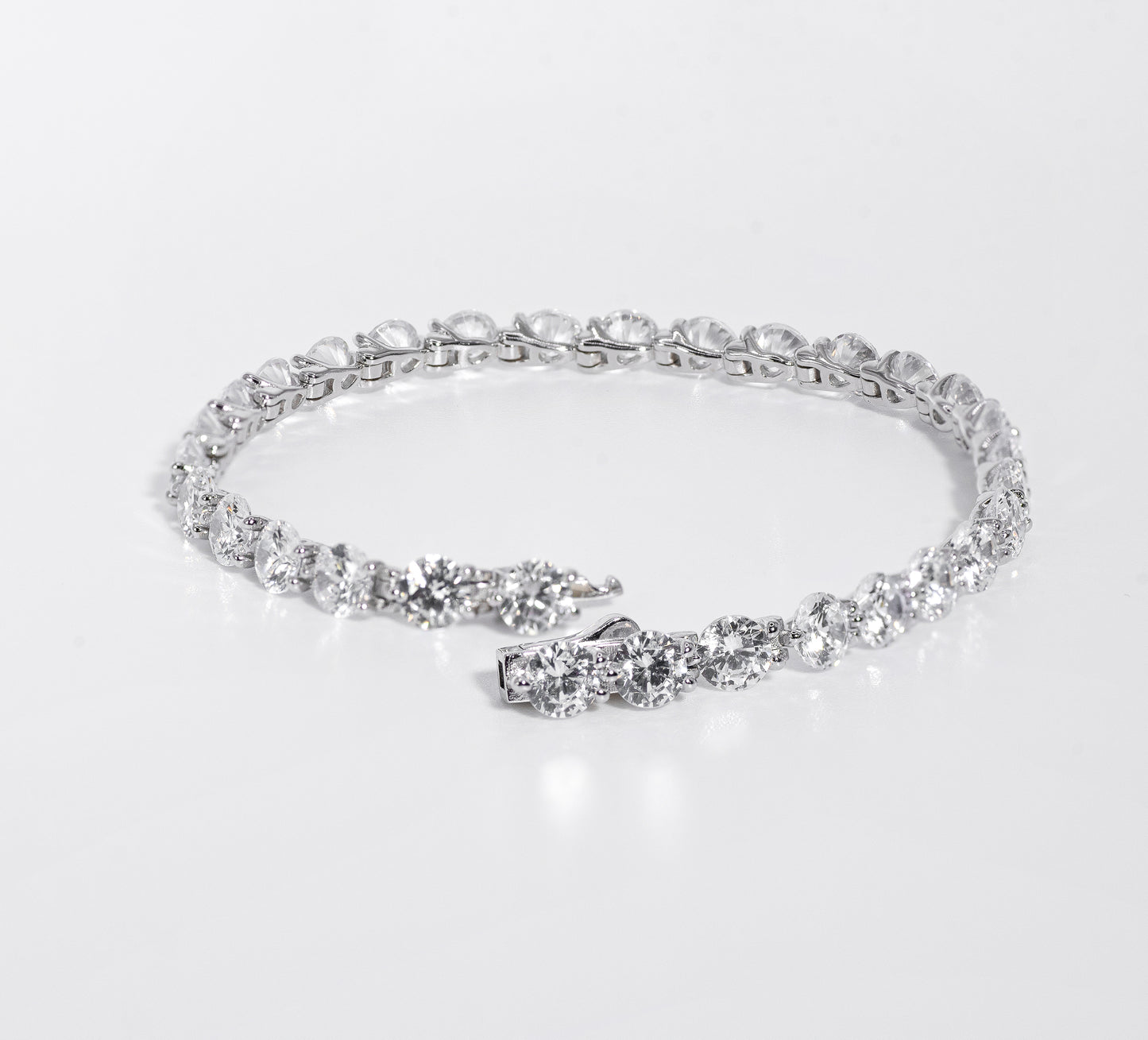 Silver bracelet with multiple gemstones on a white background