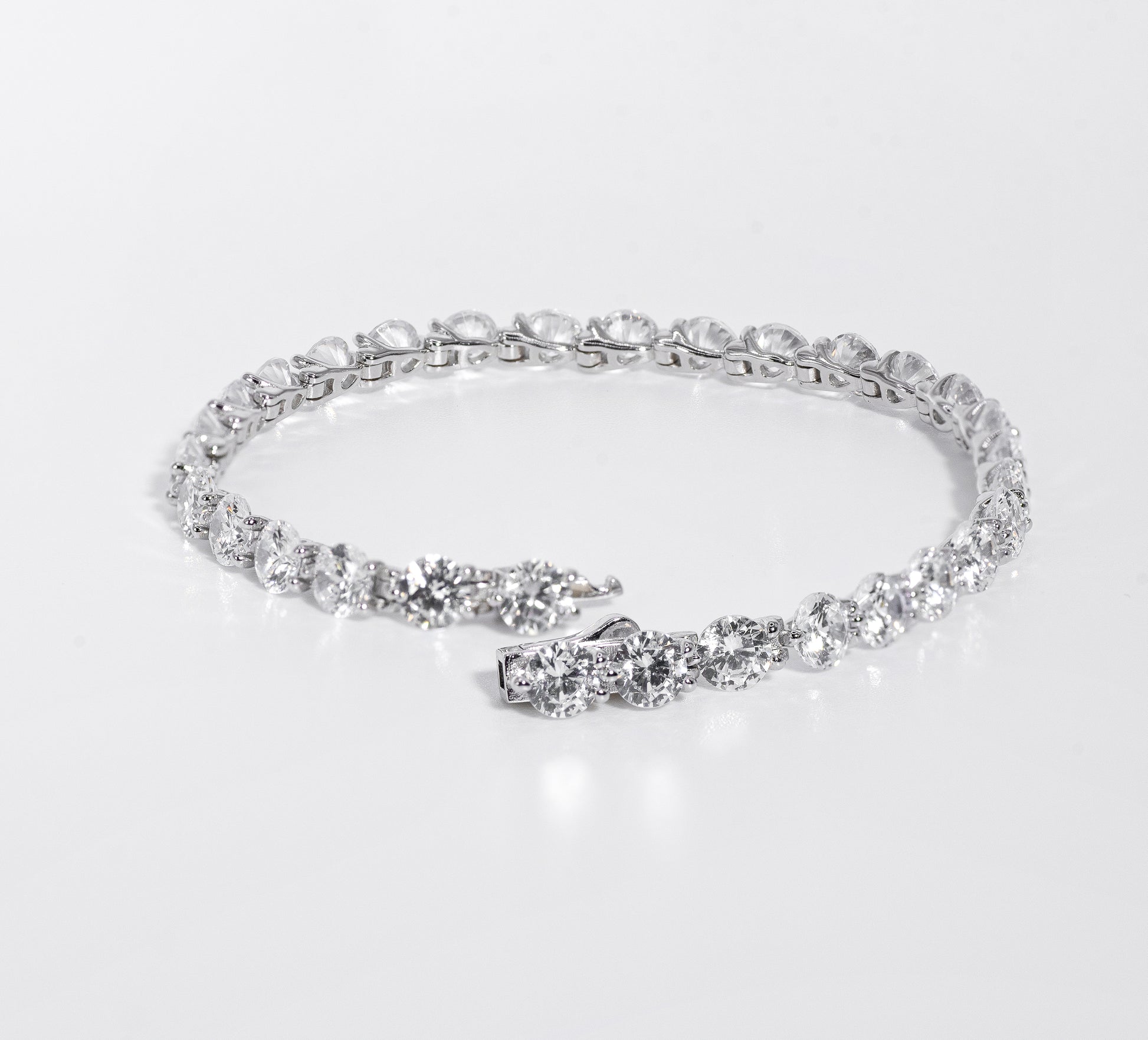 Silver bracelet with multiple gemstones on a white background