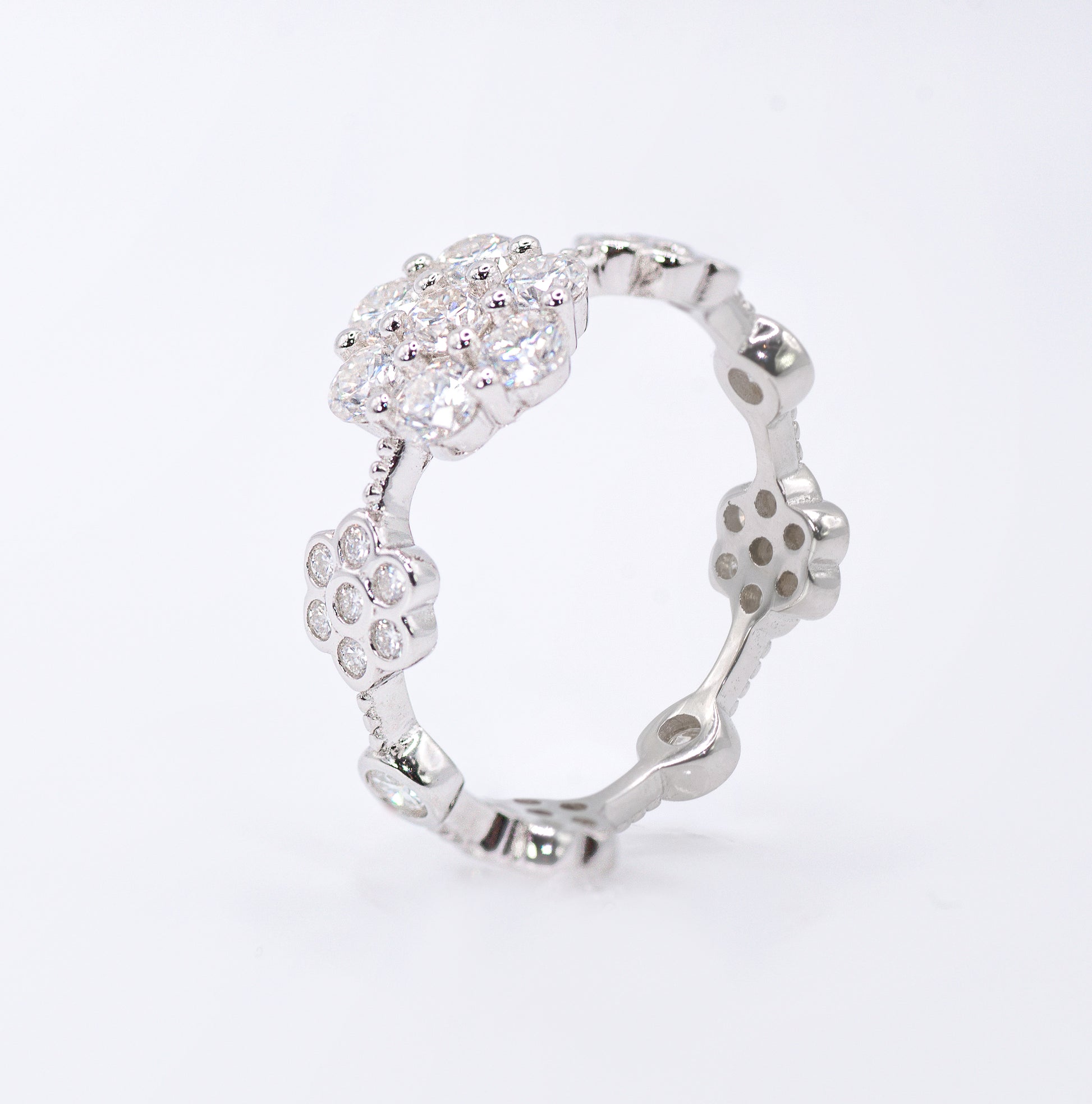 Silver ring with a floral design on a white background