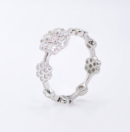 Silver ring with a floral design on a white background