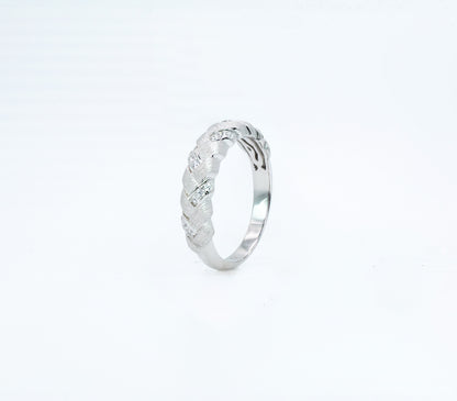 Silver ring with intricate design on a white background